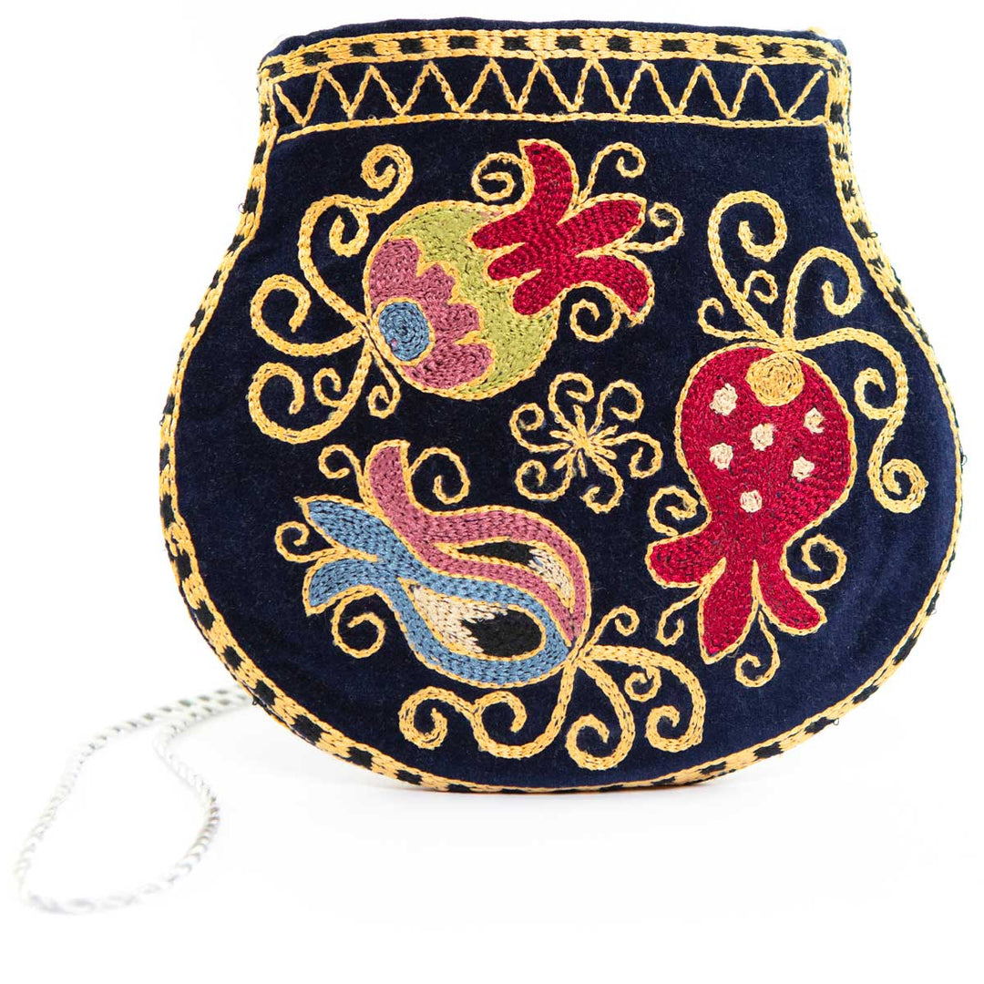 Front view with the strap down of Mekhann's botanical navy velvet pouch, showing an alternative angle of the the botanical designed pouch.