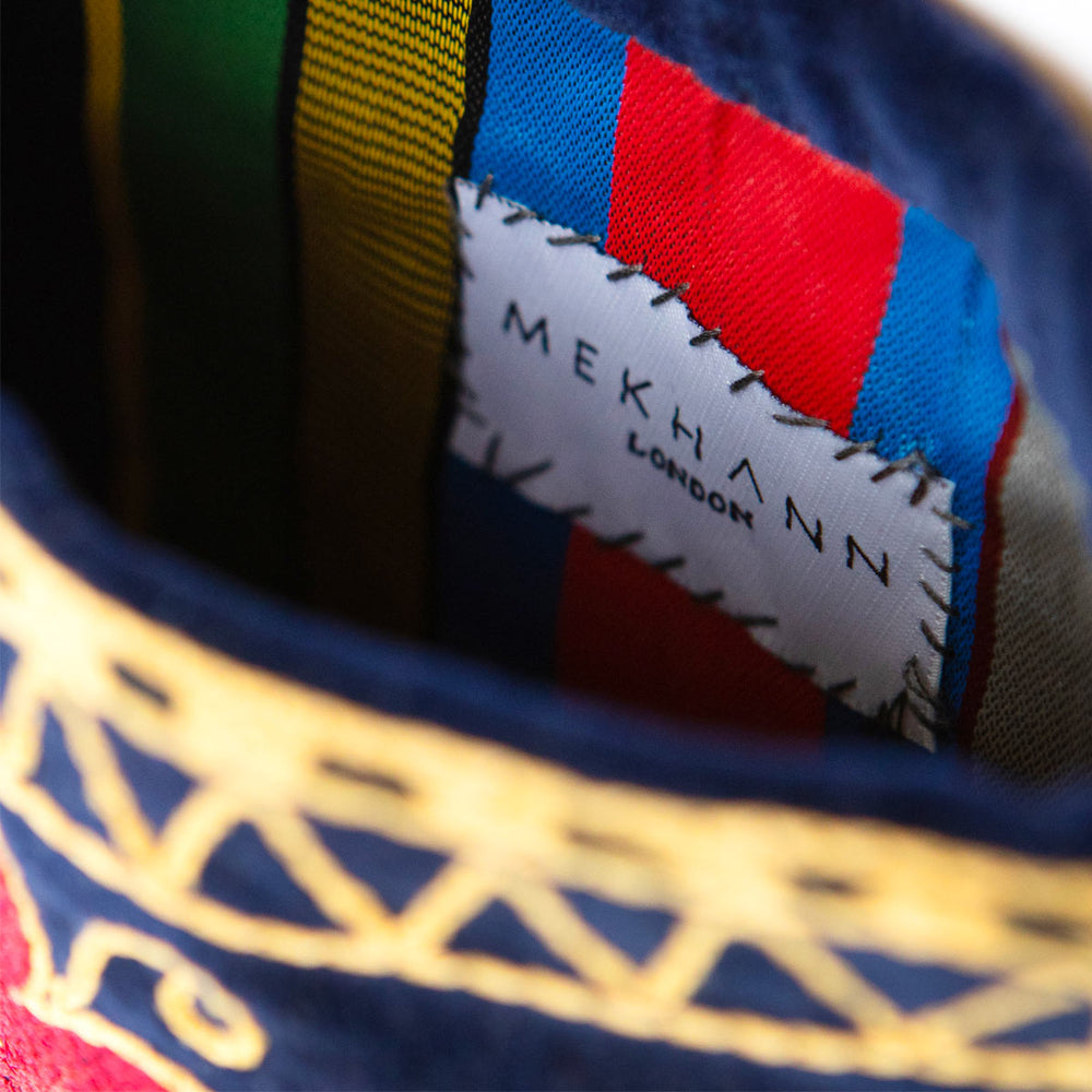 Inside view of Mekhann's botanical navy velvet pouch, displaying the colourful durable lining fabric of the bag.