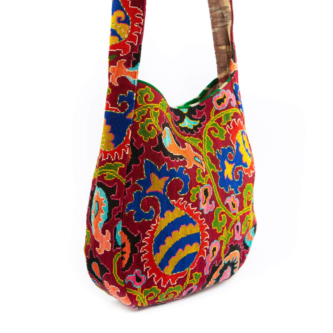 Side view of Mekhann's multicoloured large shoulder bag, featuring the side embroidery details and the comfortable strap.