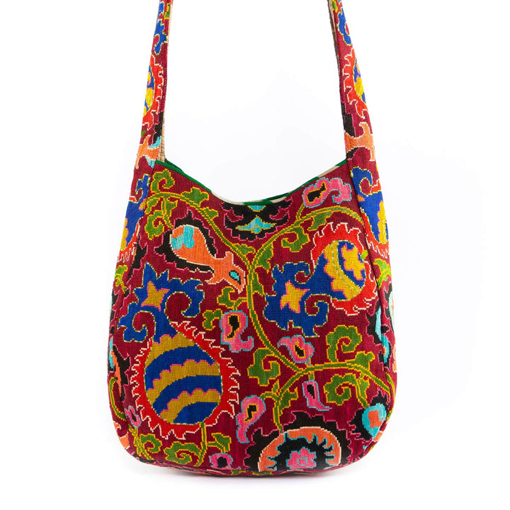 Front view of Mekhann's multicoloured embroidered large shoulder bag, with a kaleidoscopic pattern and rich colour palette