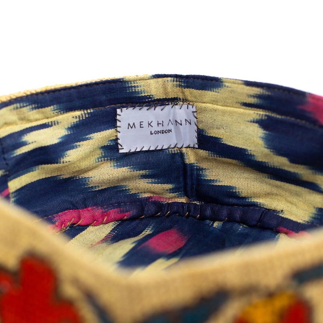 Inside view of Mekhann's botanical cream skull cap, showcasing the wonder on the ikat fabric and is in the colours blue, cream and pink, to complement the embroidered exterior.