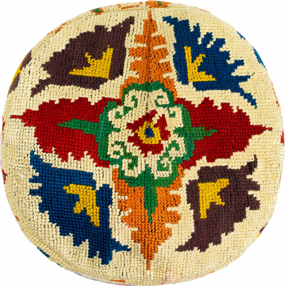 Top view of Mekhann's botanical cream skull cap, showcasing a hand embroidered botanical pattern.
