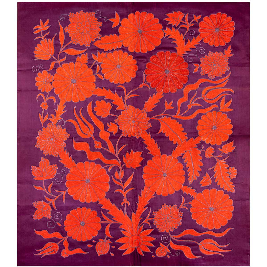 Front view of Mekhann's royal purple botanical throw, where we can see the full composition of the bright orange floral design elements that have been hand embroidered onto a royal purple silk background .