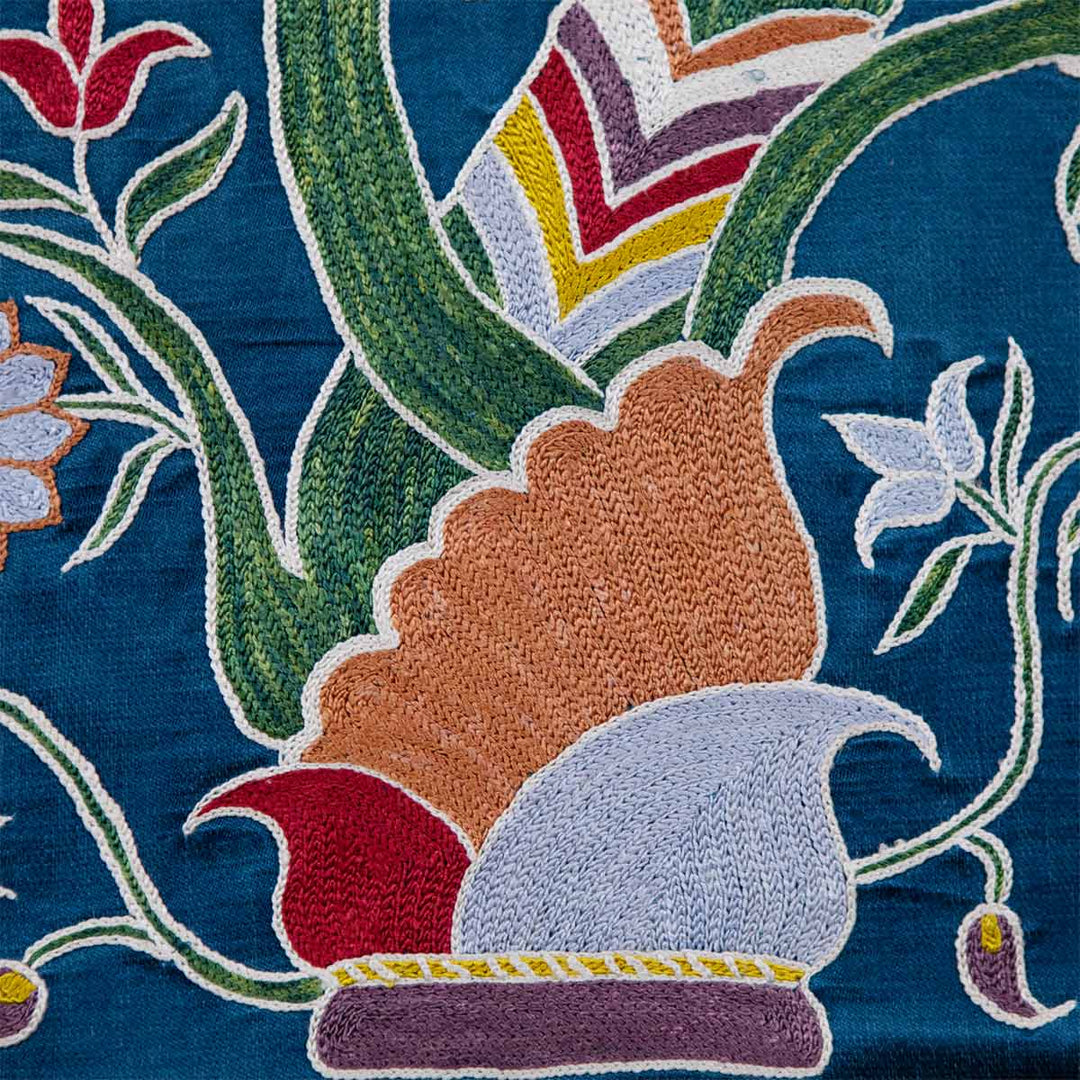 Close up view of Mekhann's navy botanical runner runner, A close-up of the navy runner highlighting the intricate embroidery and texture of the botanical tree design, with attention to the vibrant detailing.