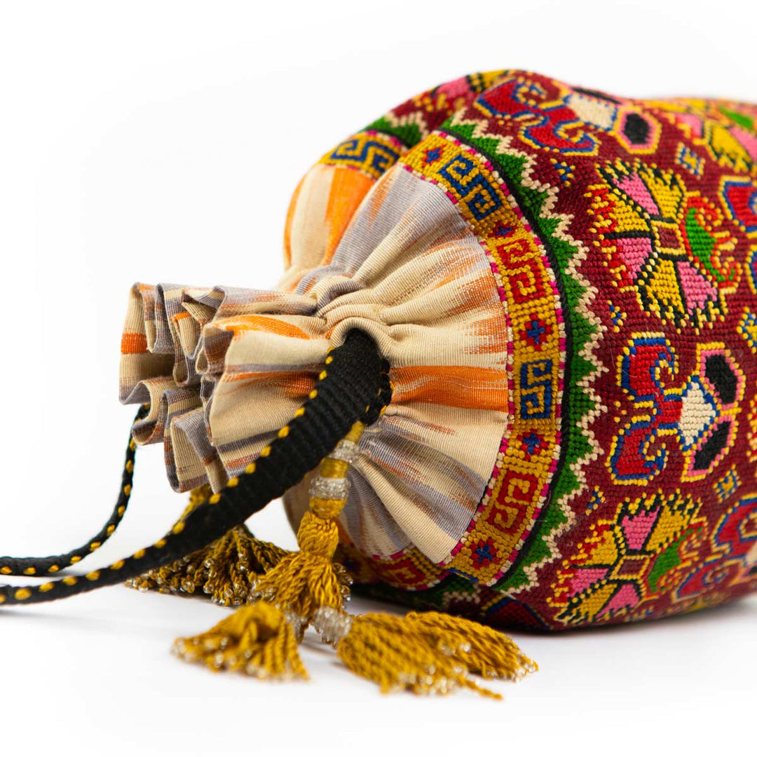 Top view of Mekhann's multicoloured embroidered carnations bucket bag, showcasing the distinctive shape and ornate design details.