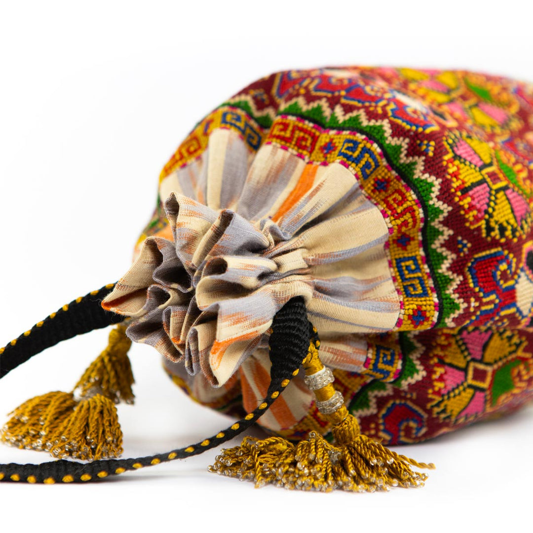 Alternative top view of Mekhann's multicoloured embroidered carnations bucket bag, further displaying the closure feature of the bucket bag. 
