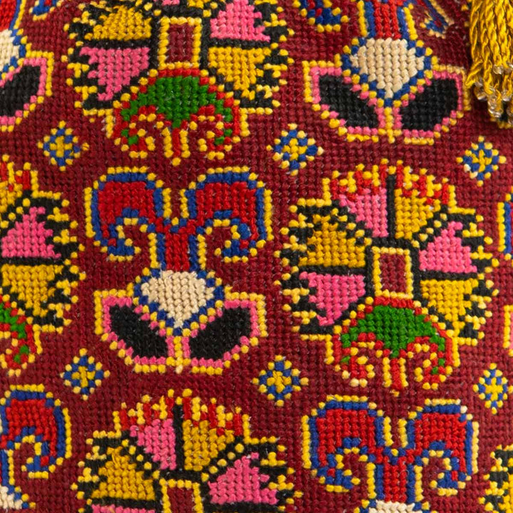 Close up view of Mekhann's multicoloured embroidered carnations bucket bag, showing off all the small details that make up the bucket bag. 