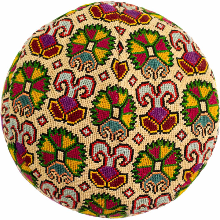 Top view of Mekhann's multicoloured carnations skull cap, showing off the collection of multicoloured carnation flowers on the cream base.
