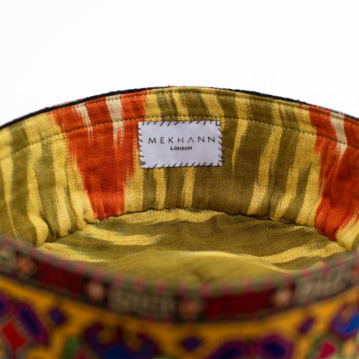 Inside view of Mekhann's yellow carnations skull cap, revealing a wonderful ikat lining in green and orange.