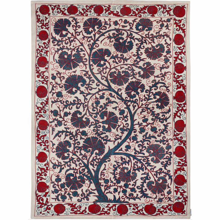 Front view of Mekhann's cream carnations tree throw,  showing the full composition of the carnations tree throw, with a bright red hand embroidered border featuring pomegranate motifs, all set on a base of cream coloured silk.