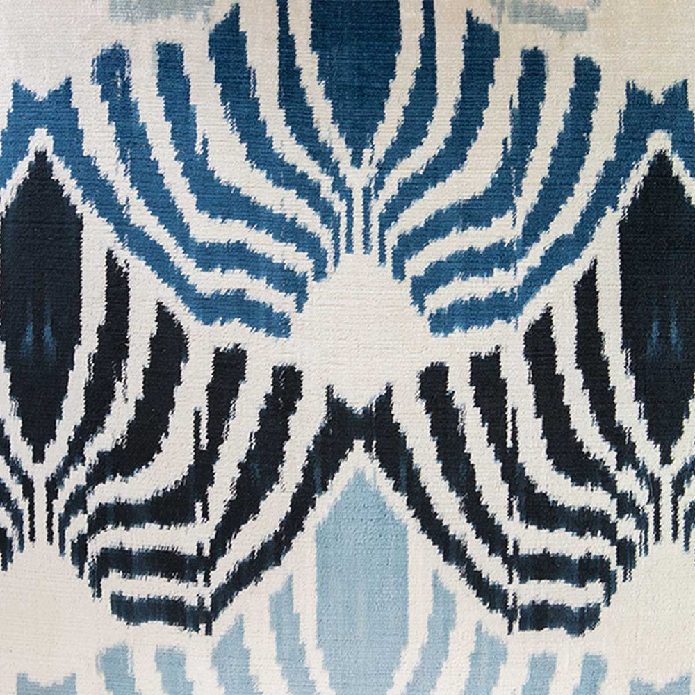 Close up view of Mekhann's blue patterns velvet cushion, showing the blue, abstract, velvet patterns up close.