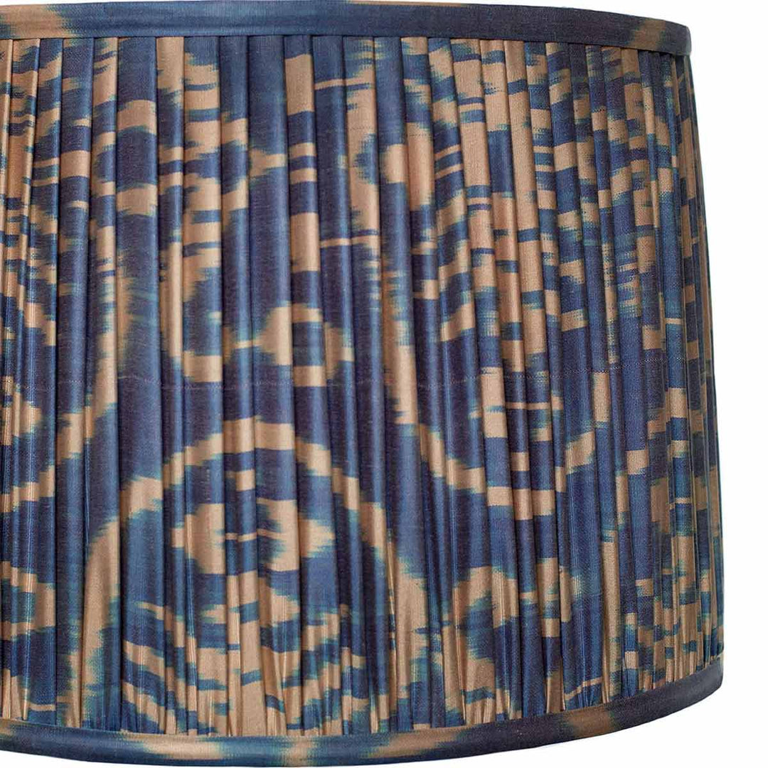 Close-up of the cream ikat design on Mekhann's navy silk lampshade, showcasing the artisanal dye work and pleated details.