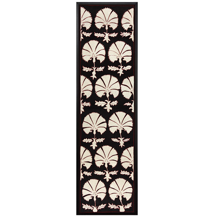 Front view of Mekhann's black and white carnations embroidered silk artwork, features a silk black background with a repeating pattern of white carnation motifs, all within a black frame.