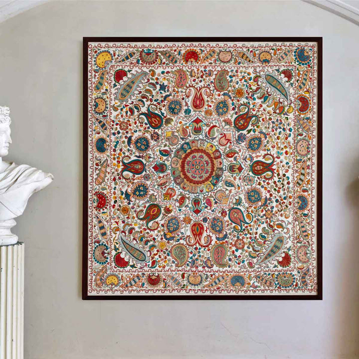 In use view of cream silk, multicoloured embroidered framed artwork, showing the embroidered artwork hung on a wall to give the viewer a better reference of size.