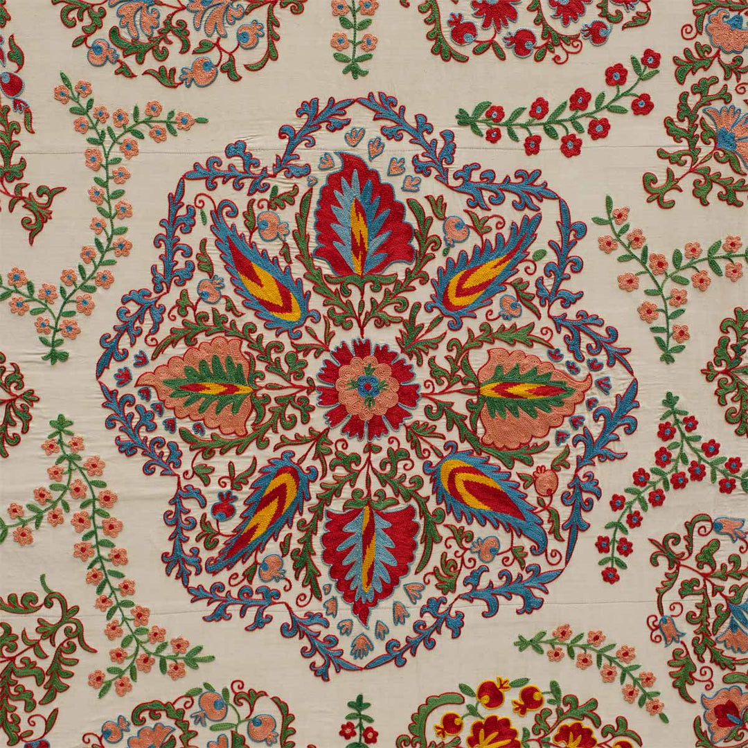 Detailed view of Mekhann's cream and multicoloured silk artwork featuring a collection of floral and botanical embroidered details. Revealing in detail the centre botanical Motif, with a collection of blue, yellow, pink and green organic patterns all hand embroidered on a base of cream silk.