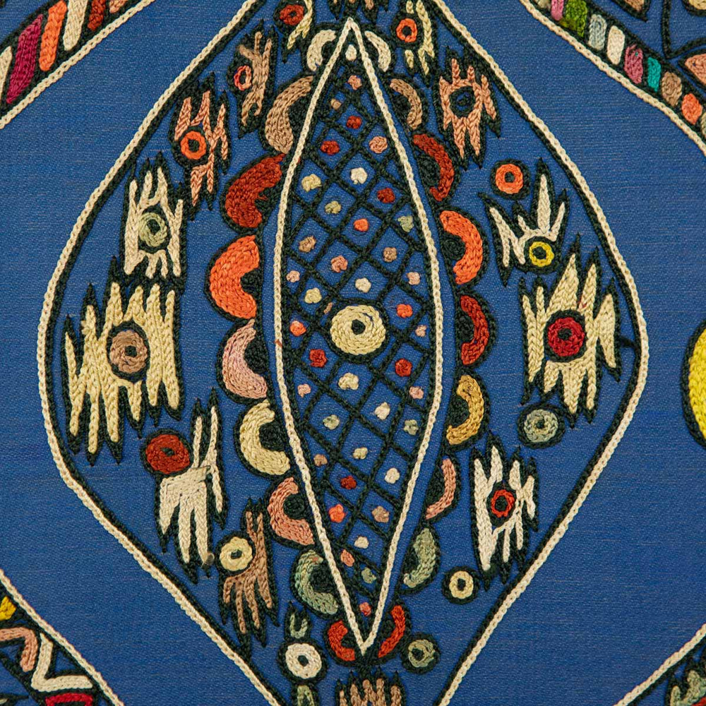 Close up view of Mekhann's navy silk hand embroidered artwork, showing the inside of one of the patterns showing a collection of abstract embroidered shapes on a base of navy silk.