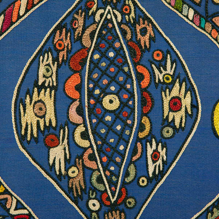 Close up view of Mekhann's navy silk hand embroidered artwork, showing the inside of one of the patterns showing a collection of abstract embroidered shapes on a base of navy silk.