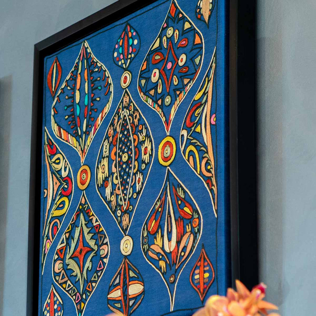 In use view of Mekhann's navy silk hand embroidered artwork, showcasing a unique angle of viewing the artwork to give an alternative view.