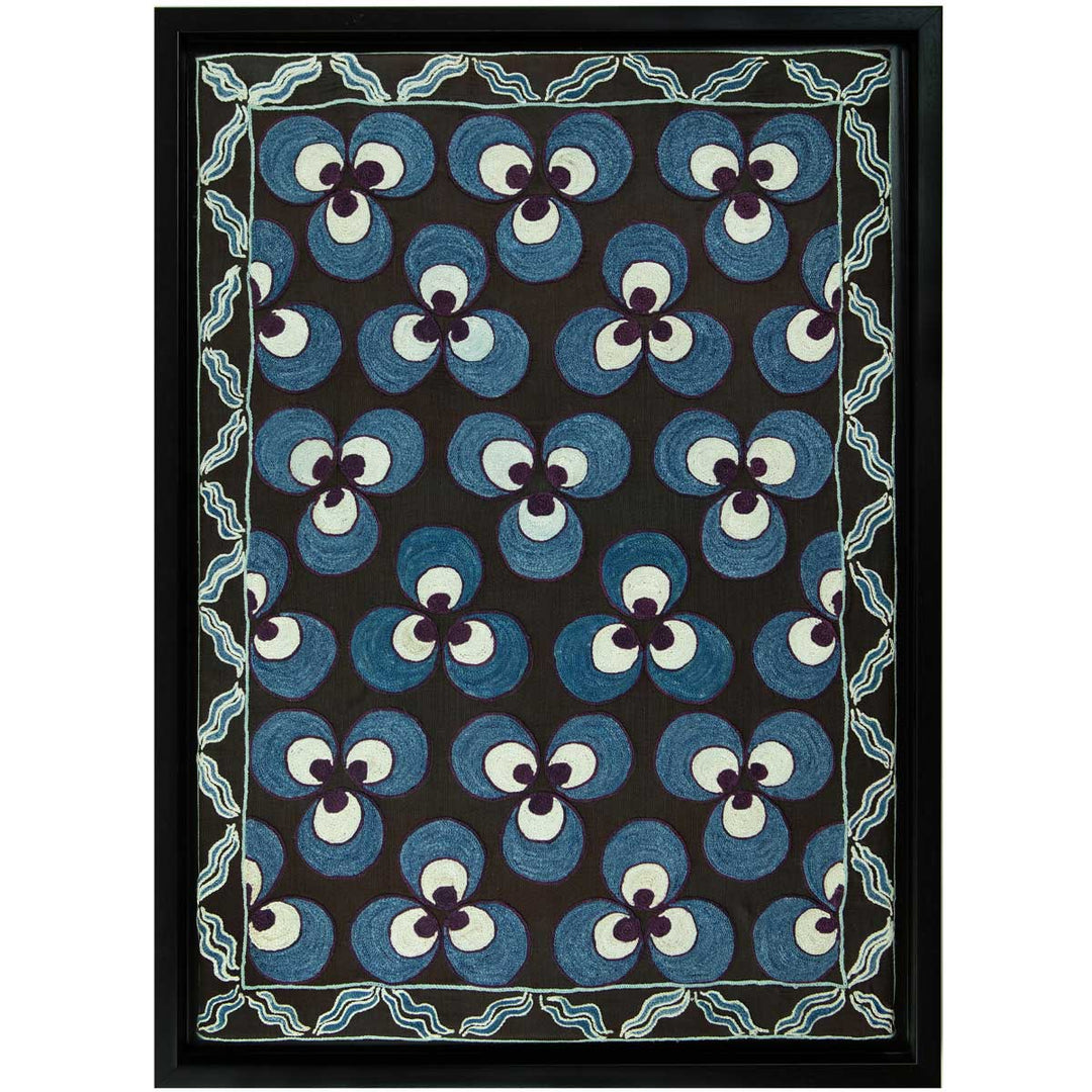 Front view of Mekhann's hand embroidered black silk cintamani artwork, showing the full blue and black circle embroidery on a base of black silk, with a black frame to match.