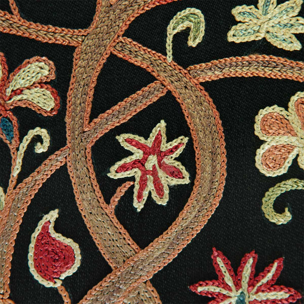 Close up view of Mekhann's black silk garden artwork, revealing how the branches of the tree interweave with each other in a light brown shade, with small red flowers growing for the branches.