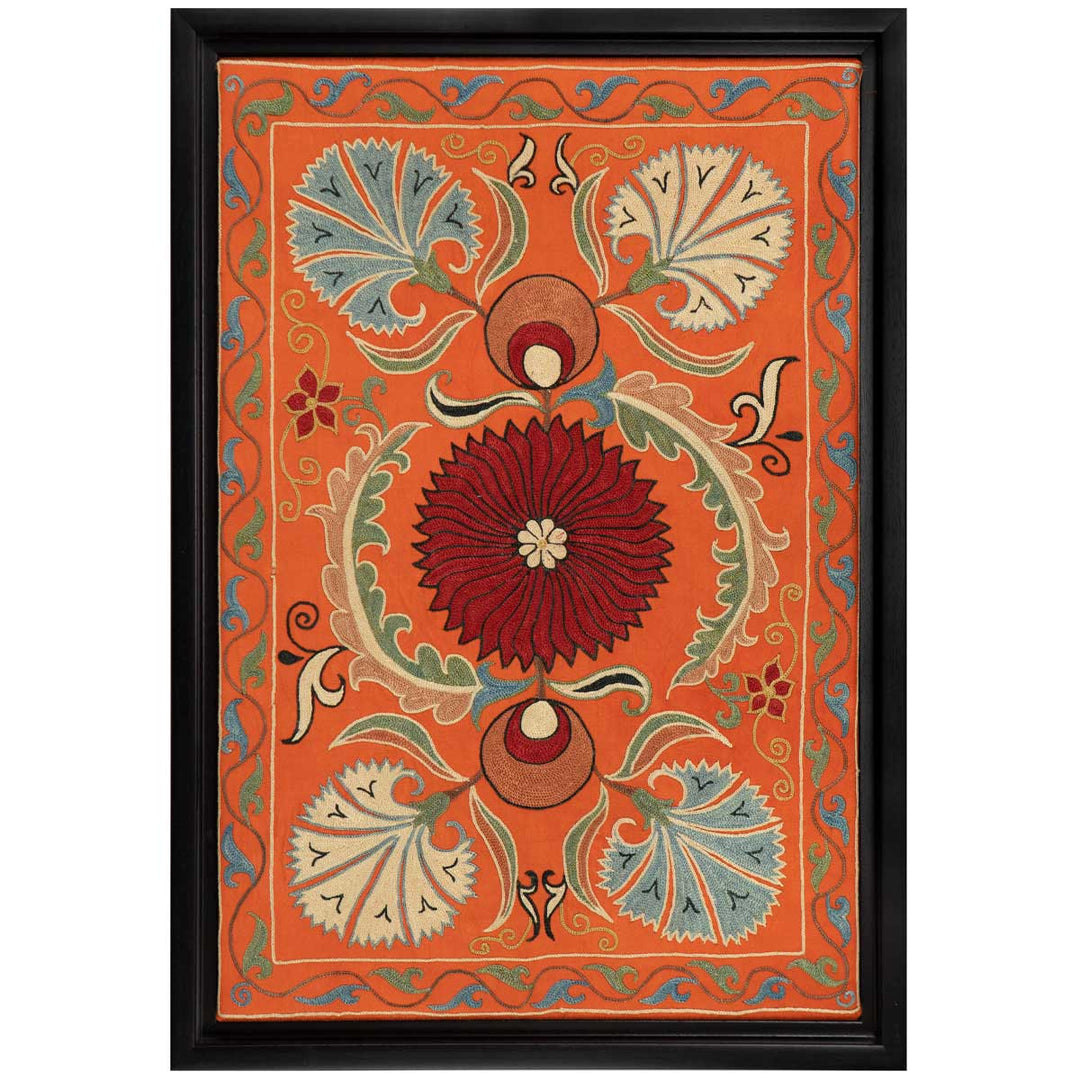Front view of Mekhann's orange silk floral artwork, ramed in black, featuring a central bold red floral motif surrounded by delicate blue and cream carnation flowers all hand embroidered on a base of orange coloured silk.