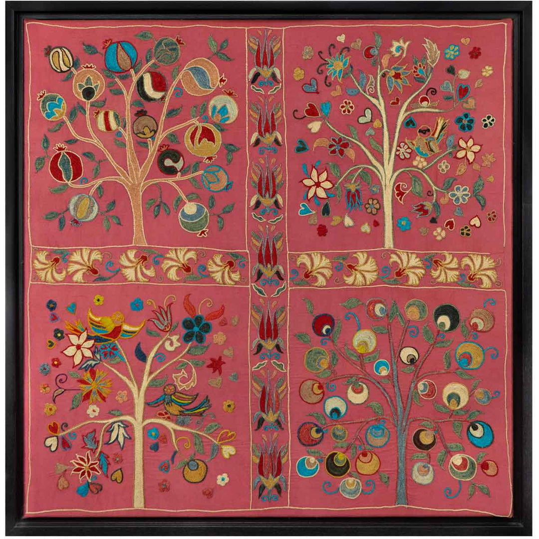 Front view of Mekhann's pink silk hand embroidered artwork, with a display of four trees all adored with different organic shapes and patterns on a base of pink silk.