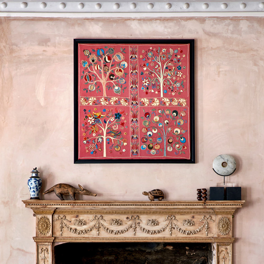 In use view of Mekhann's pink silk hand embroidered artwork, shown above a fireplace to give sizing context for the artwork. 
