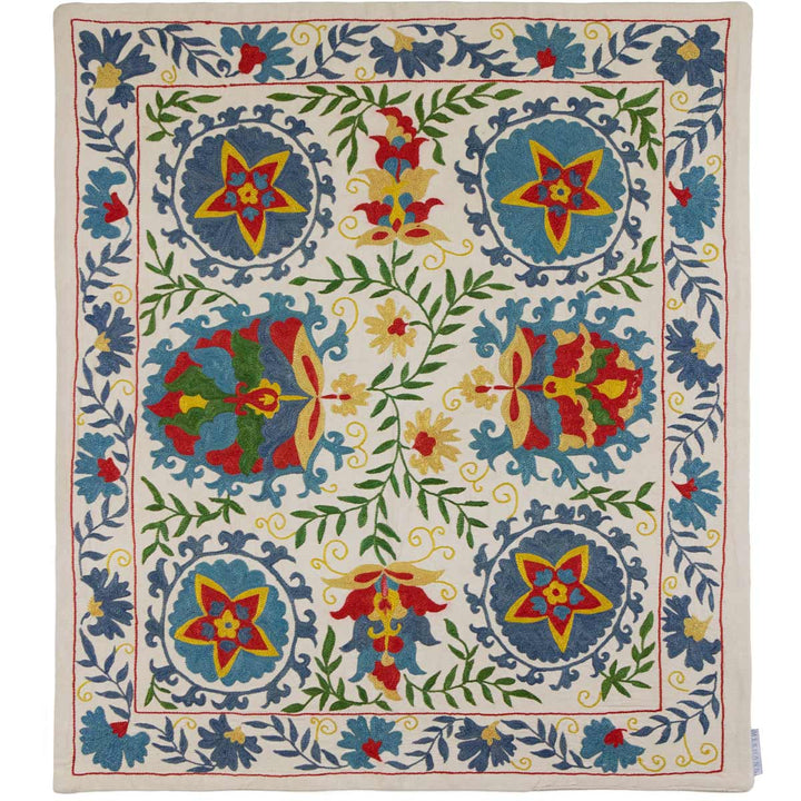 Front view of Mekhann's cream iznik petite throw, with an exquisite array of multicoloured floral and geometric patterns, displayed in full view.