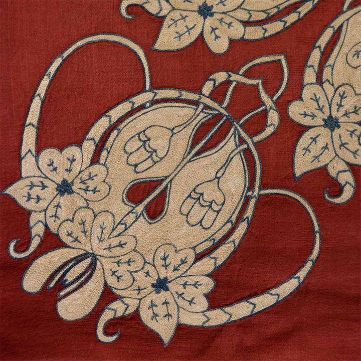 Detail view of Mekhann's maroon baroque petite throw, showcasing the plush silk  fabric and ornate hand  embroidery.