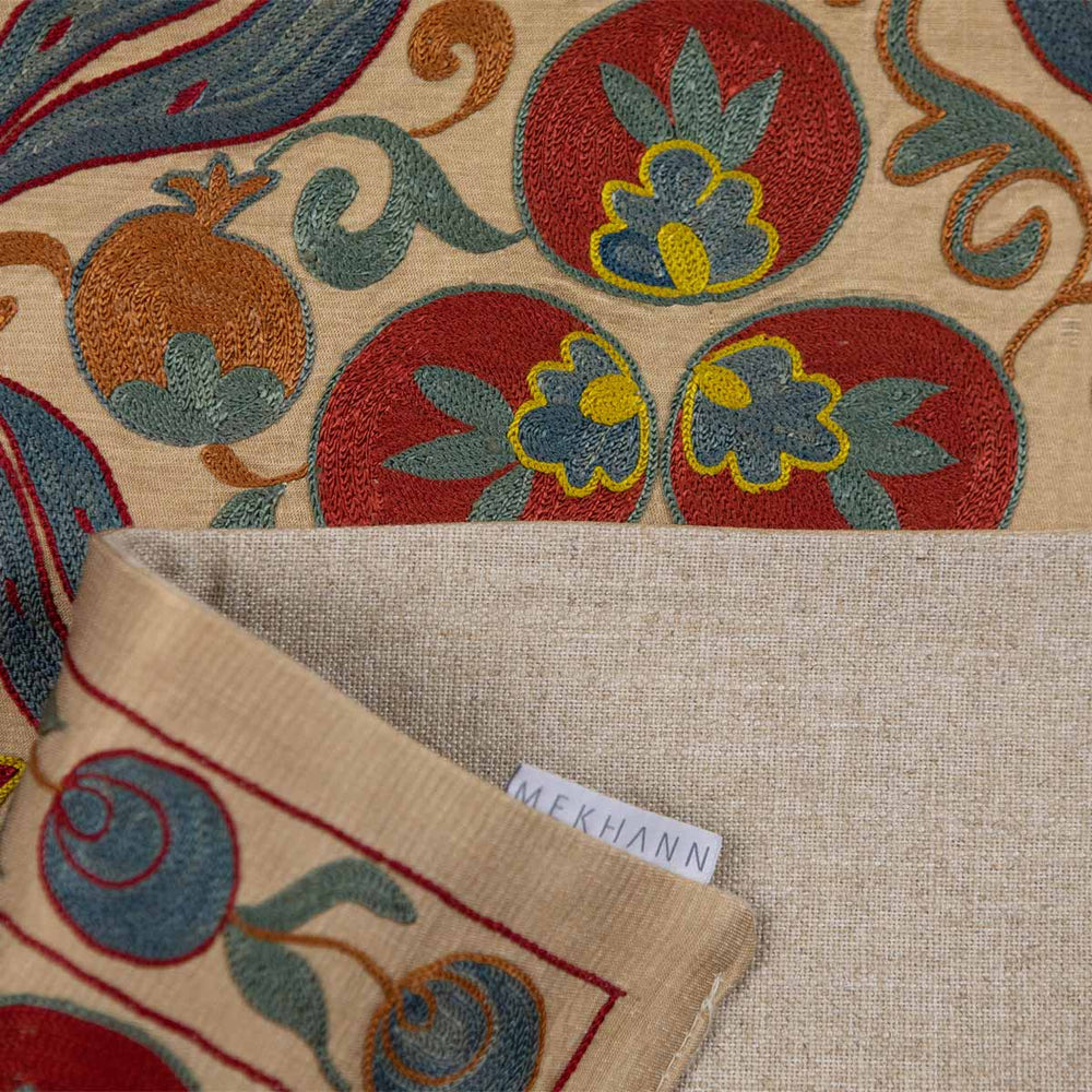 Folded view of Mekhann's multicoloured cintamani runner, with the back lining in full display in a beige colour with the Mekhann label on display.