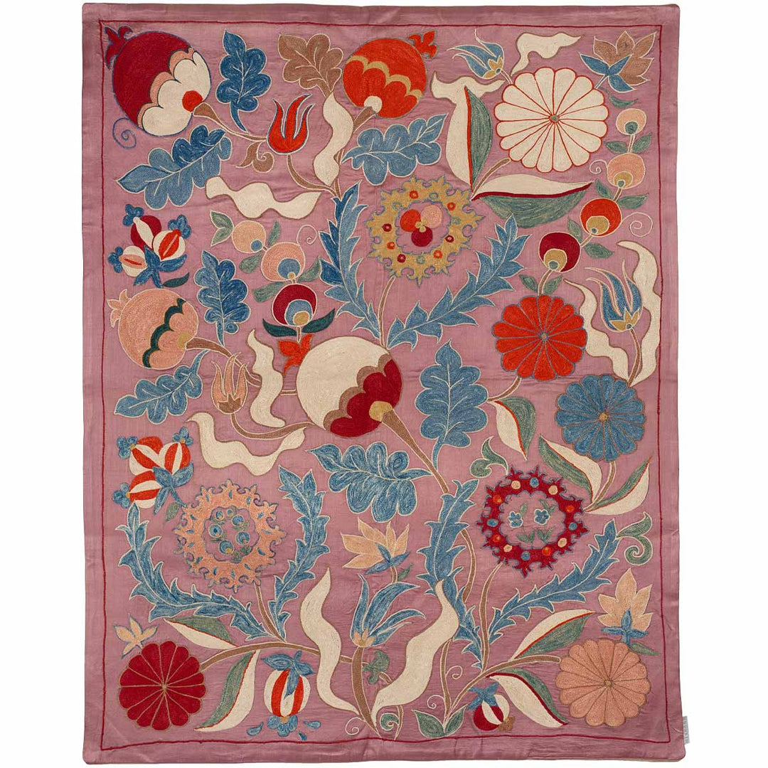 Front view of Mekhann's violet iznik throw, with a collection of floral and organic iznik patterns that have been hand embroidered onto a violet silk base. All the iznik patterns are hand embroidered, with the main colours being blue, red and white.