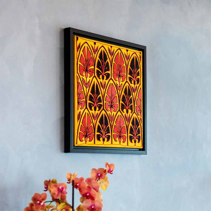 In use view of Mekhann's yellow silk artwork with black and red embroidered patterns, showing the size of the framed artwork hung on a wall to give a better idea of dimensions.