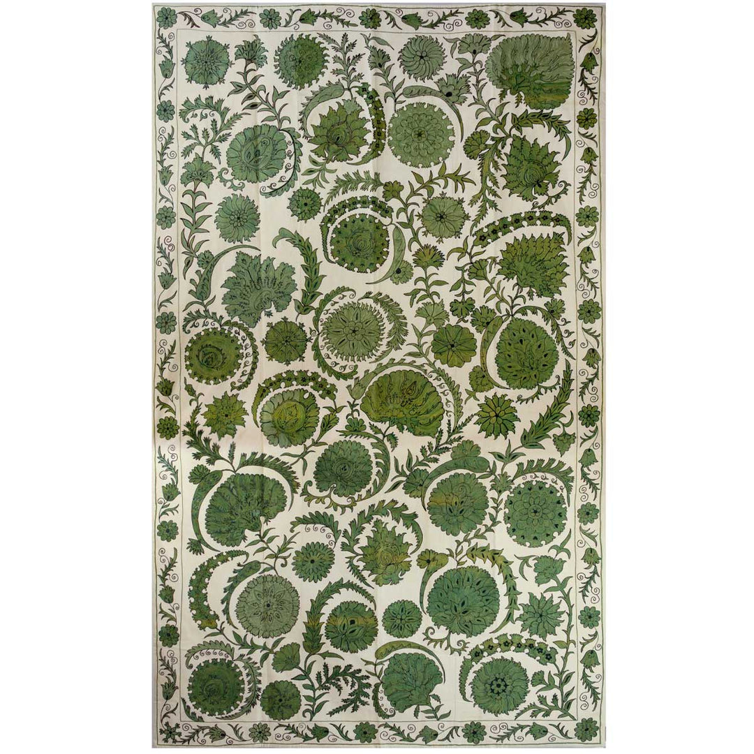 Front view of Mekhann's emerald botanical throw, revealing the grand composition of the throw with all the green botanical detailing hand embroidered on a base of cream coloured silk that perfectly contrasts the green embroidery.