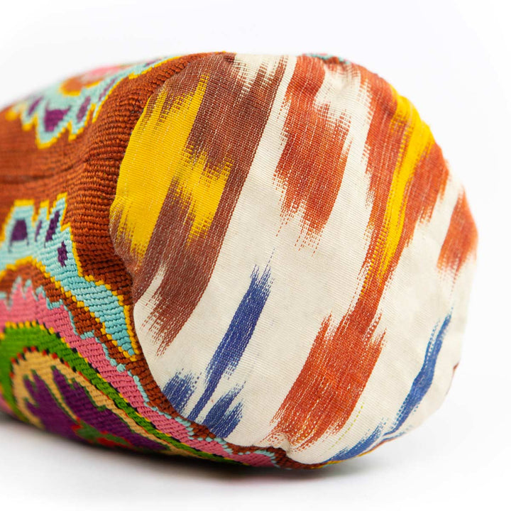 Bottom view of Mekhann's multicoloured floral embroidered bucket bag, show off the flat ikat base pf the bag.