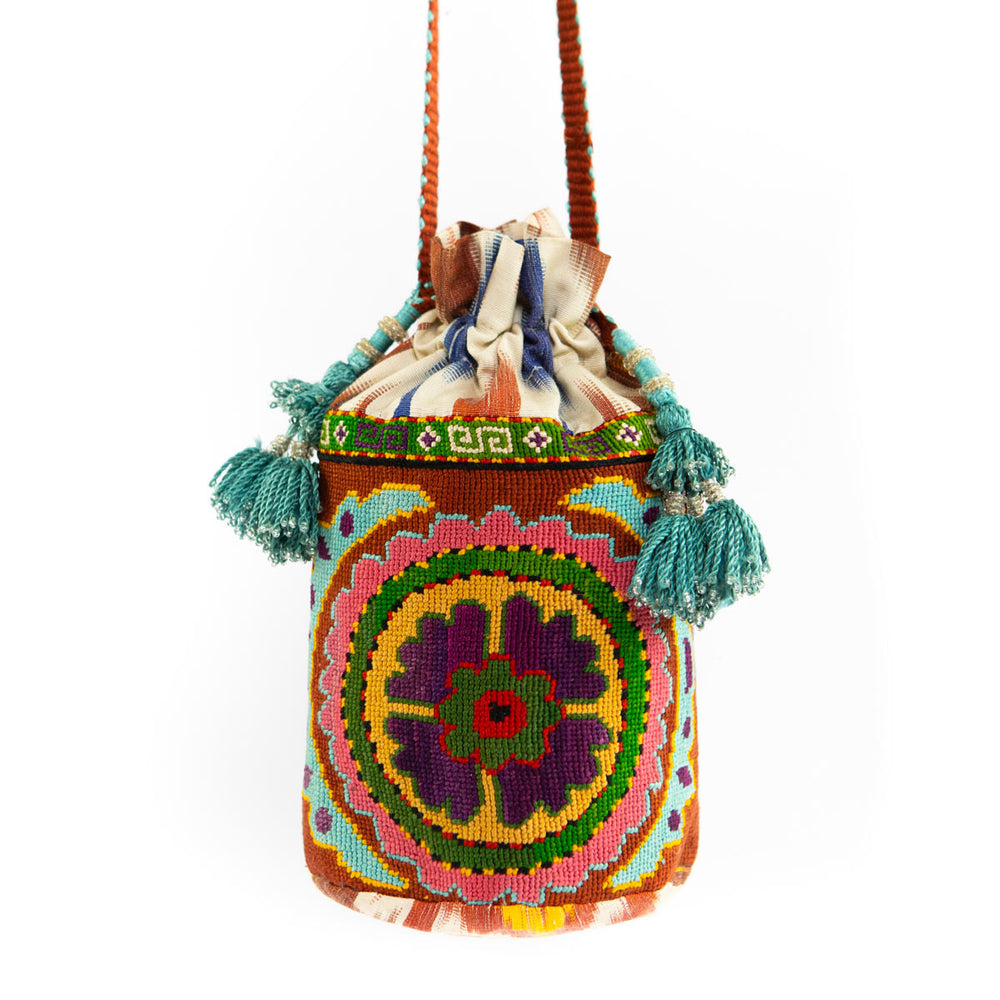 Full front view of Mekhann's multicoloured floral embroidered bucket bag, showing the entire bag with the detail of the straps.