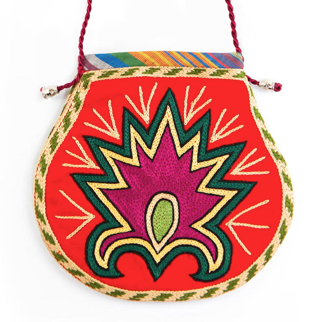Front view of Mekhann's floral light maroon velvet pouch, displaying a centre flower in pink and green.