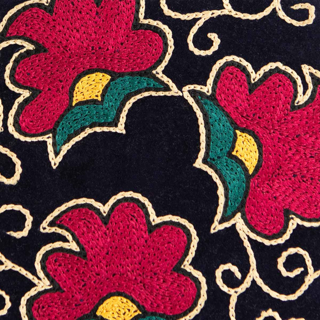 Close up view of Mekhann's floral navy velvet pouch, showing in more detail the craftsmanship and care in every stitch of the pouch.