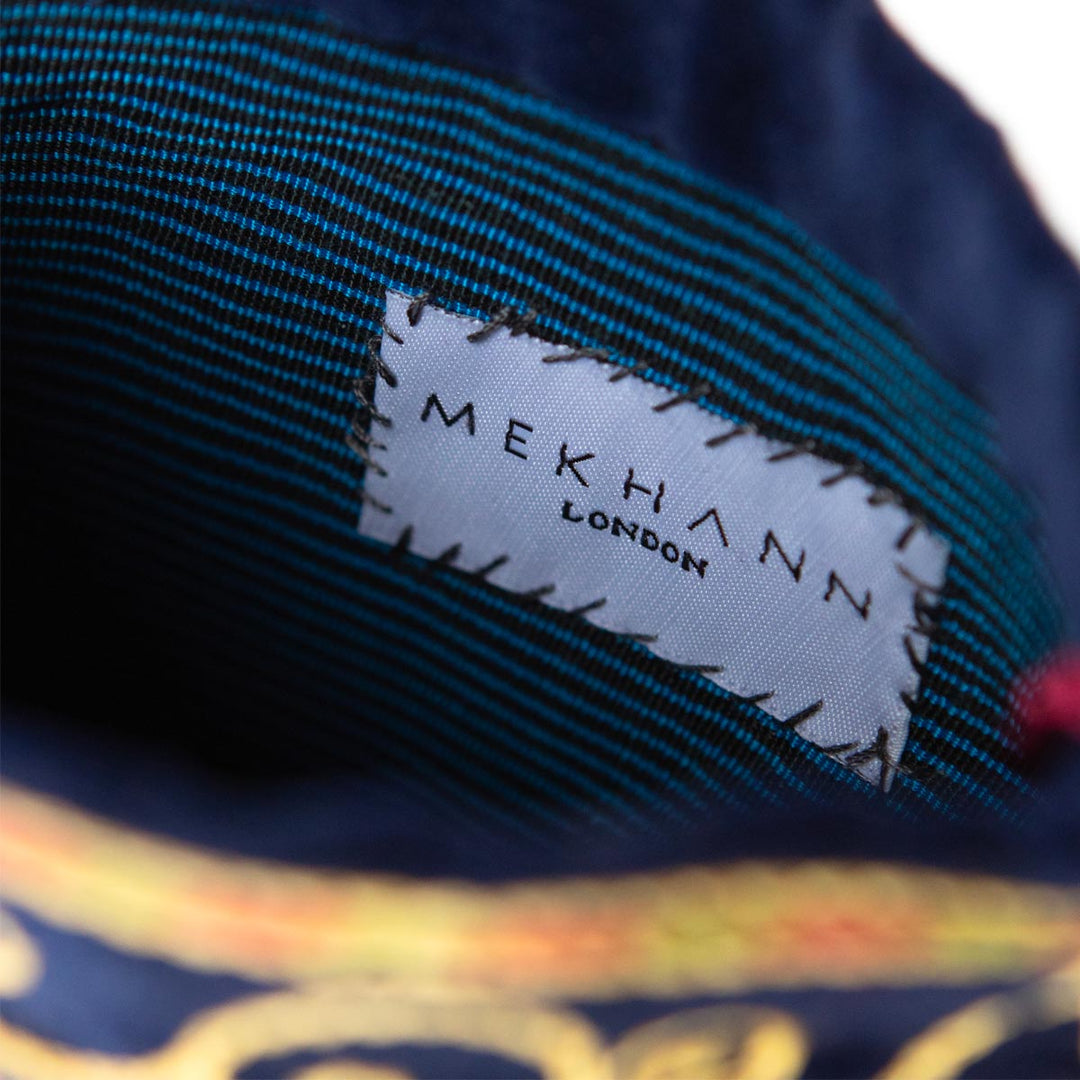 Inside view of Mekhann's floral navy velvet pouch, showing the quality lining fabric of the pouch.