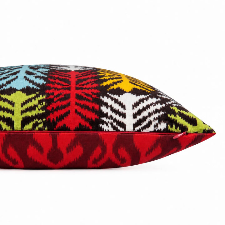 Side and zip detail of the Frond Cushion in Charcoal, showing the red Ikat reverse. 