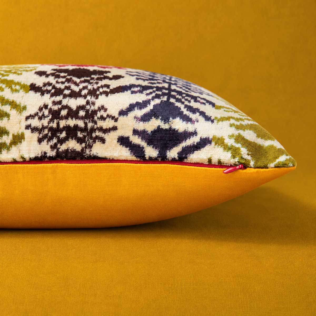 Side and zip detail of the Frond Cushion in Ivory, showing the Saffron reverse. 