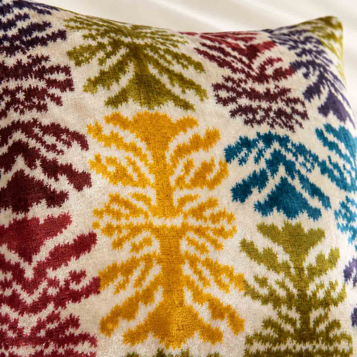 Close-up of the multicoloured velvet pattern on the Ivory Frond Cushion. 