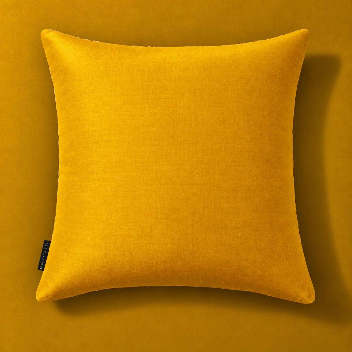 Saffron reverse of the Frond Cushion in Ivory. 