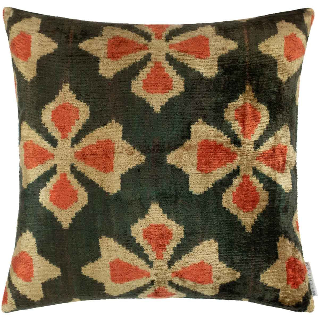 Front view of Mekhann's black and orange velvet cushion, revealing a cross like design of pattens in cream and orange on a base of black velvet.