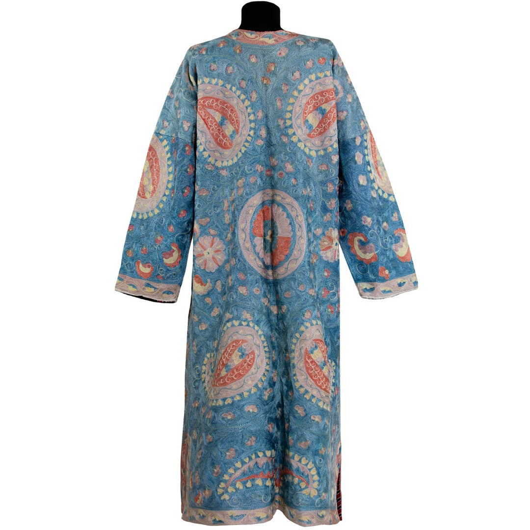 Back view of Mekhann's fully embroidered lividus II kaftan in navy, revealing continued patterns and embroidered that has moved front the front to the back of the kaftan.