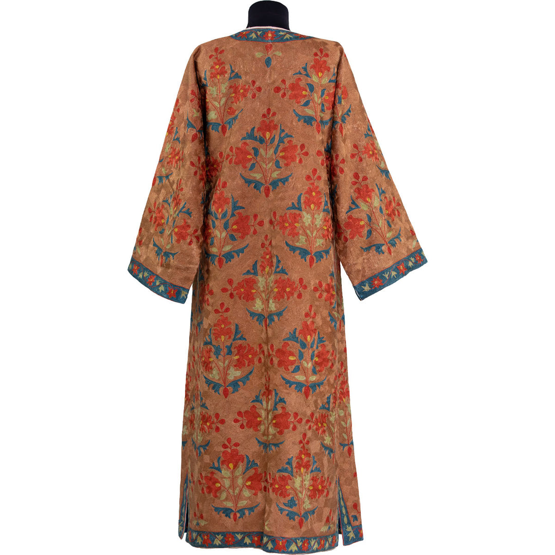 Back view of Mekhann's fully embroidered aurantius kaftan in orange, featuring a continuous embroidery design that spreads all over to the back, with clean finish along the seams.