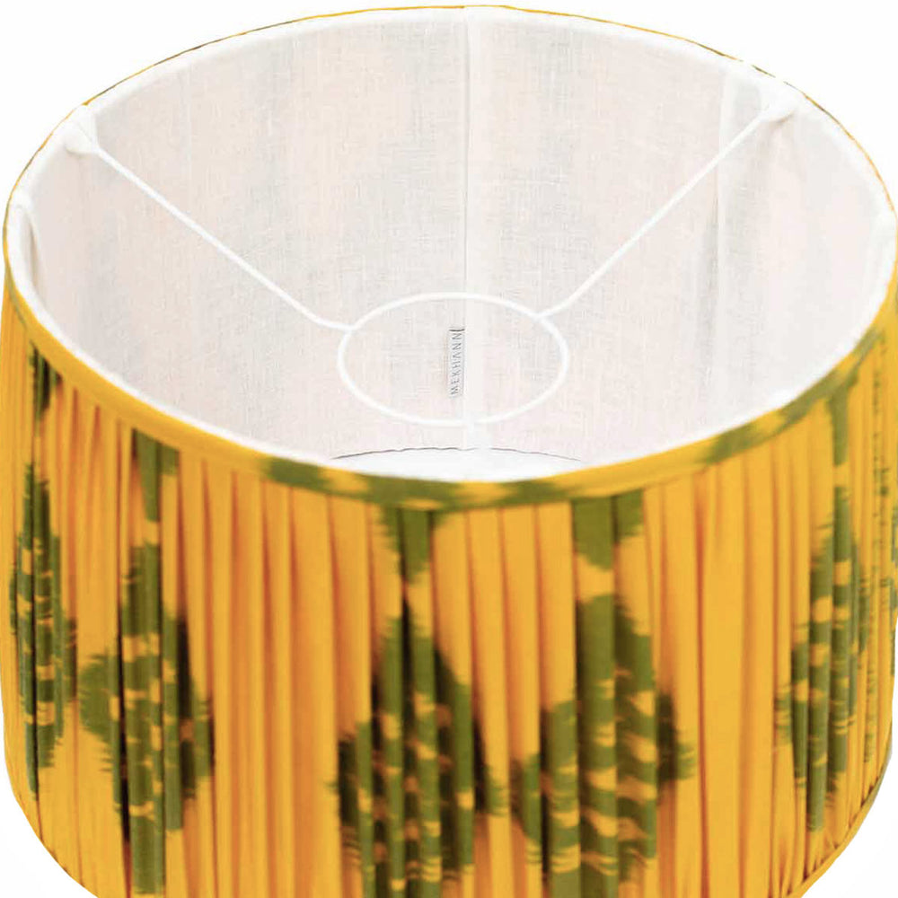 Interior view showing the lustrous silk and the detailed green ikat design on Mekhann's saffron-coloured lampshade.