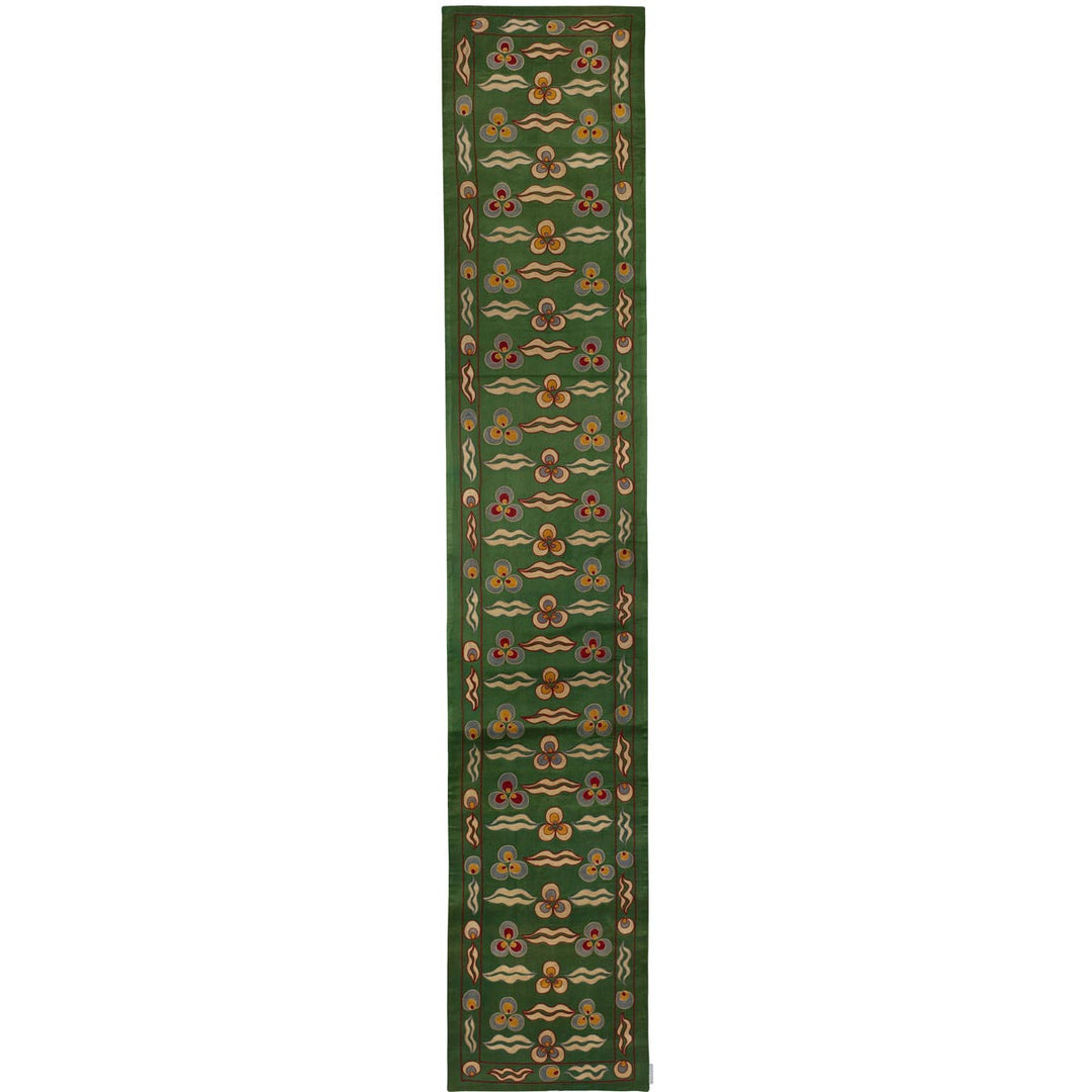 Front view of Mekhann's green cintamani runner, a celebration of hand embroidered cintamani patterns surround by other decorative elements that cover the entirety runner, all patterns have been hand embroidered on a base of green coloured silk.
