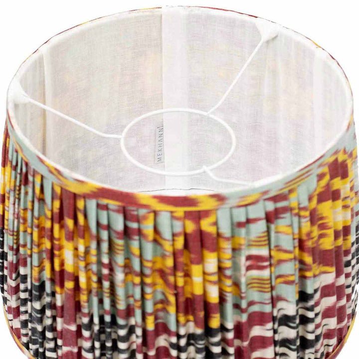 Interior shot of Mekhann's ikat lampshade, with its vivid multicolour pattern showcasing the artisanal silk pleating.