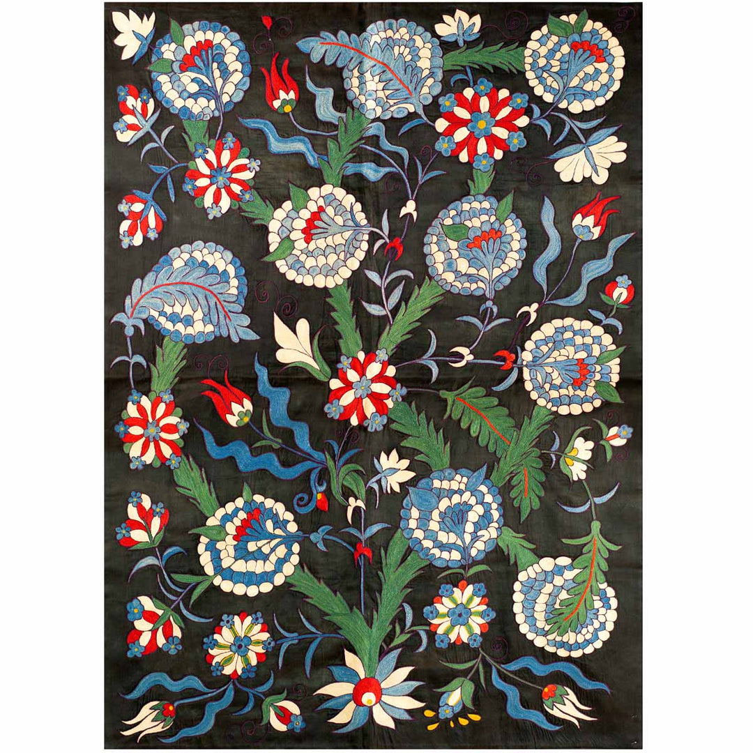 Front view of Mekhann's black iznik throw, showing an collection of floral and botanical patterns in reds, blues, greens, and white that have all been hand embroidered on a base of black silk.