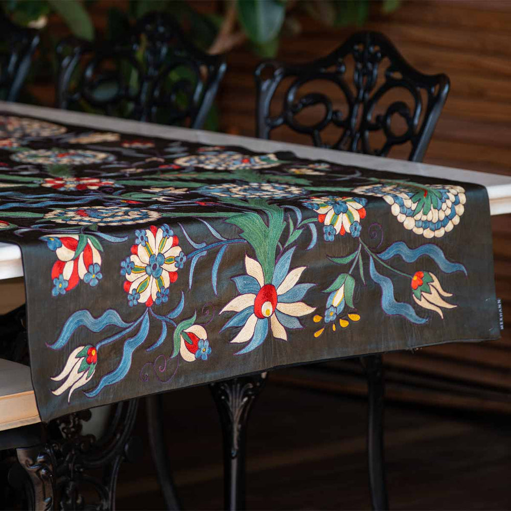 In use view of Mekhann's black iznik throw, showing the black iznik throw as part of a table display giving an idea of how the product can be used.